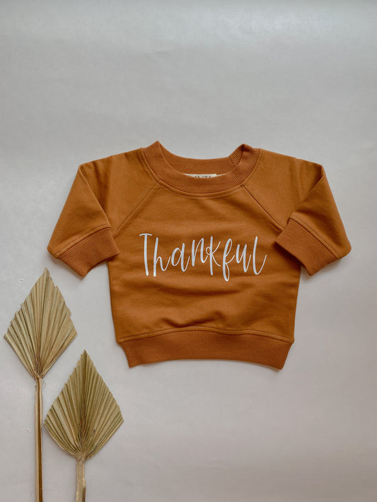 organic cotton pullover for babies personalized with the word "thankful"